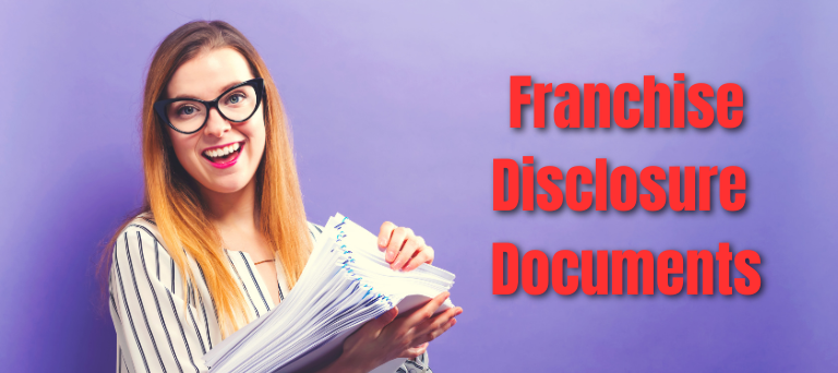 Woman holding a pile of franchise disclosure documents